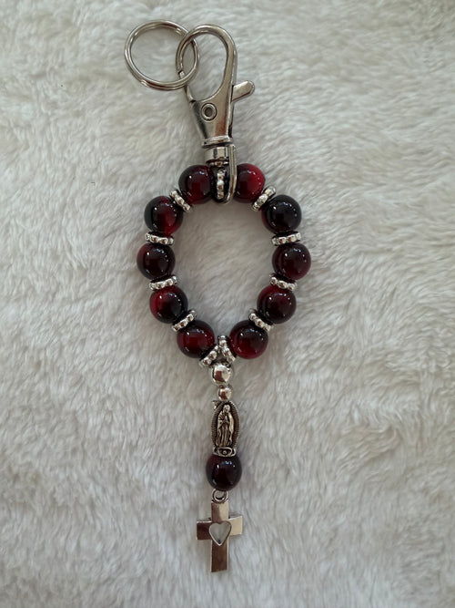 Rosary bracelet with red and cream speckled stone beads and silver hardware