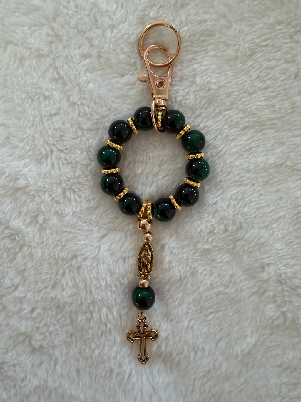 Rosary bracelet with red and cream speckled stone beads and gold hardware