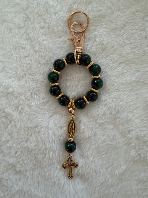 Rosary bracelet with red and cream speckled stone beads and gold hardware