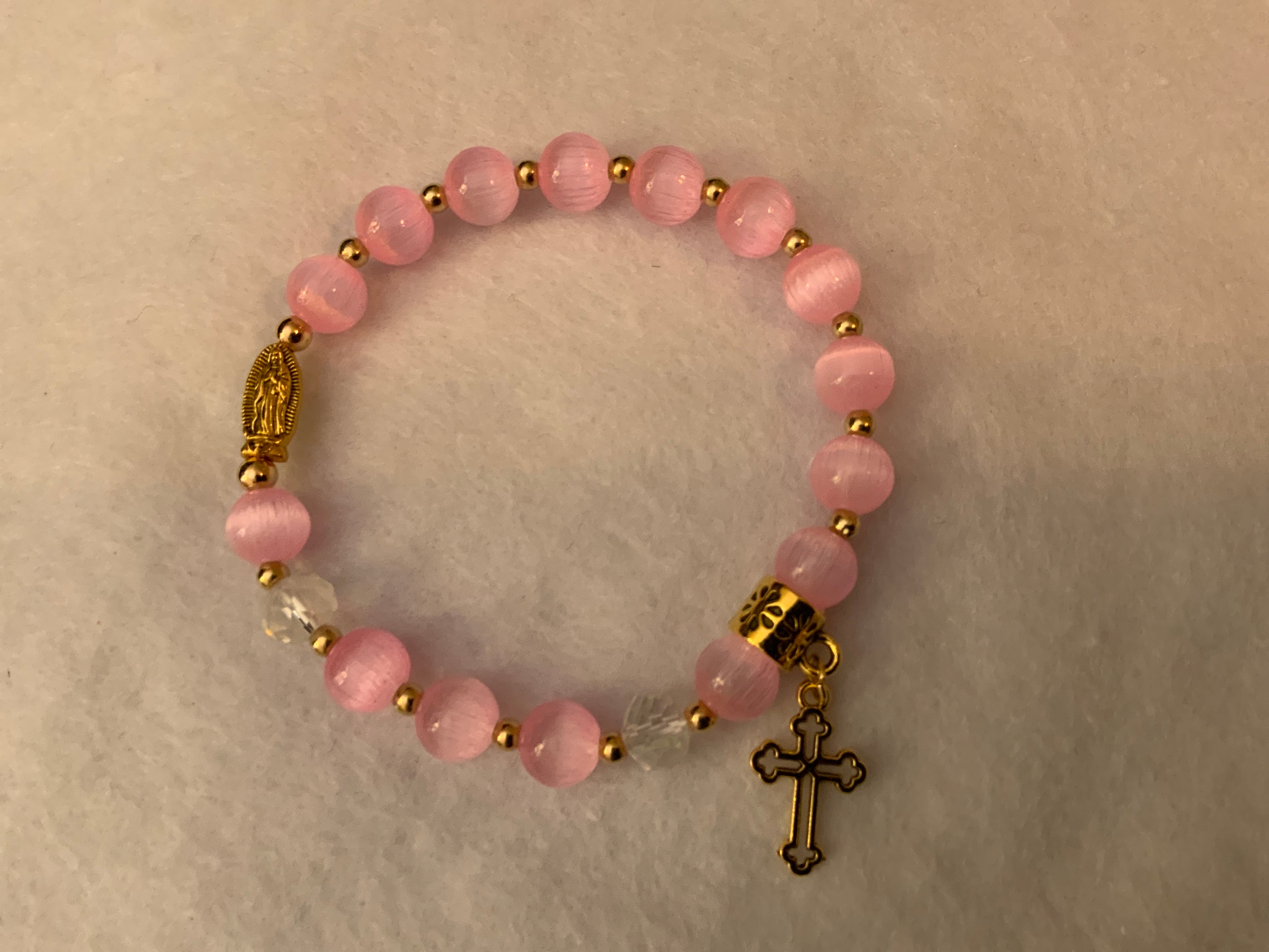 Rosary bracelet with pink cat's eye beads and gold hardware