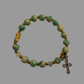 Blue green turquoise in gold color setting and Guadalupe and cross charm