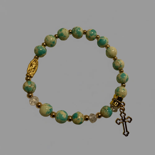 Blue green turquoise in gold color setting and Guadalupe and cross charm